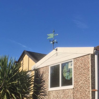 copper verdigris banner weathervane installed